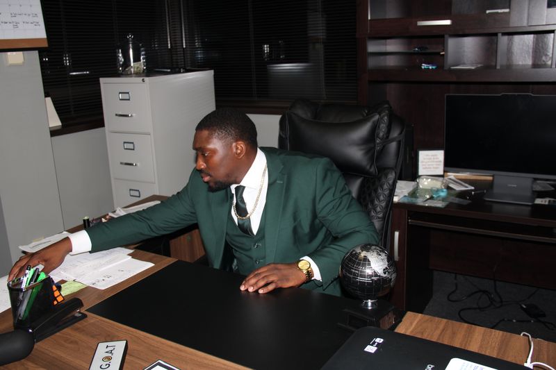 An Absalute Management team member reaching for documents at his desk