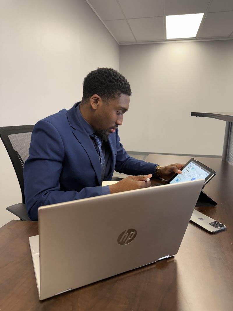An Absalute Management team member reviewing account details at his desk